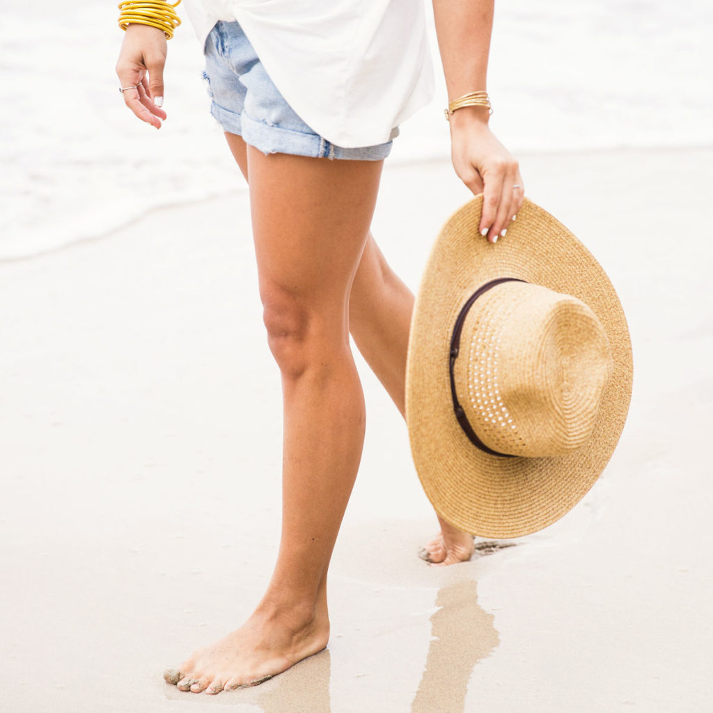 Tips avoiding burnout - woman walking in shorts along the water